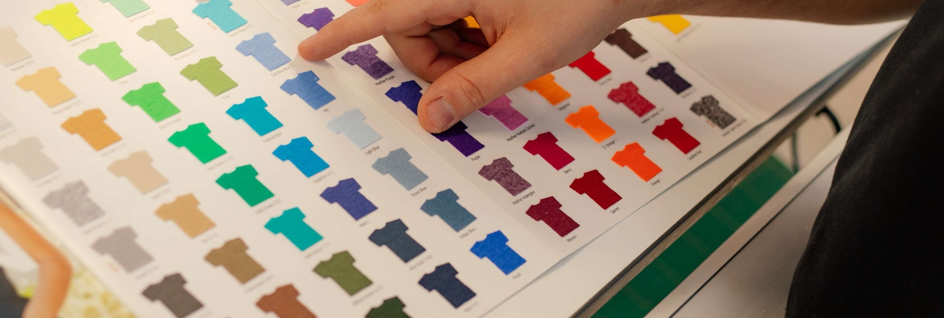 Person choosing samples from a catalog